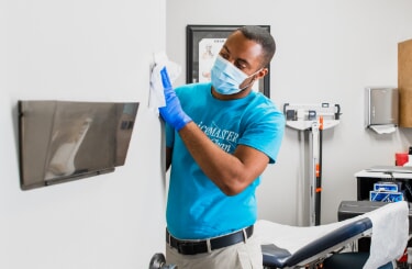 ServiceMaster Clean professional cleaning a medical office door